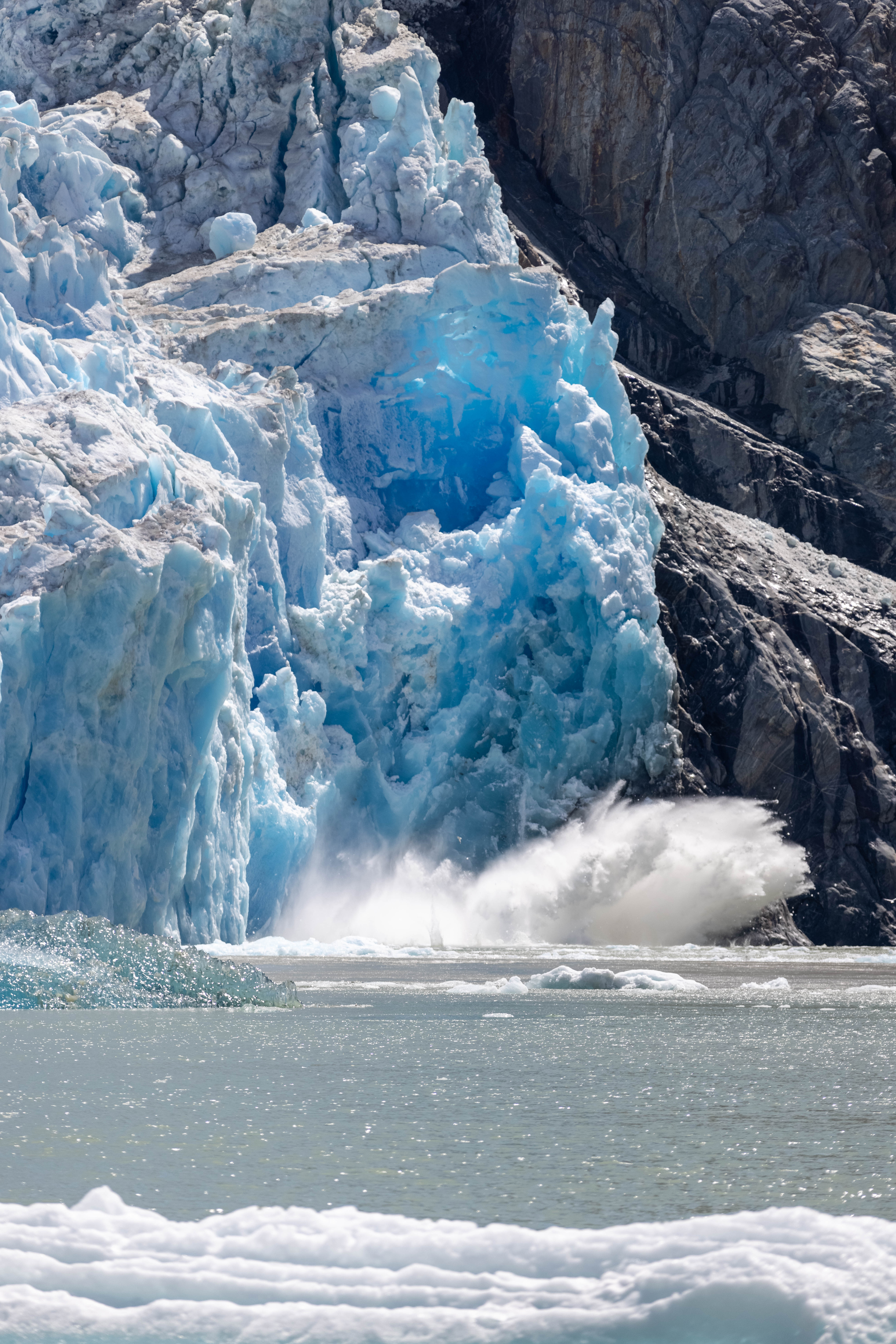 Water splashes as the Sawyer Glacier calves in Tracy Arm fjord