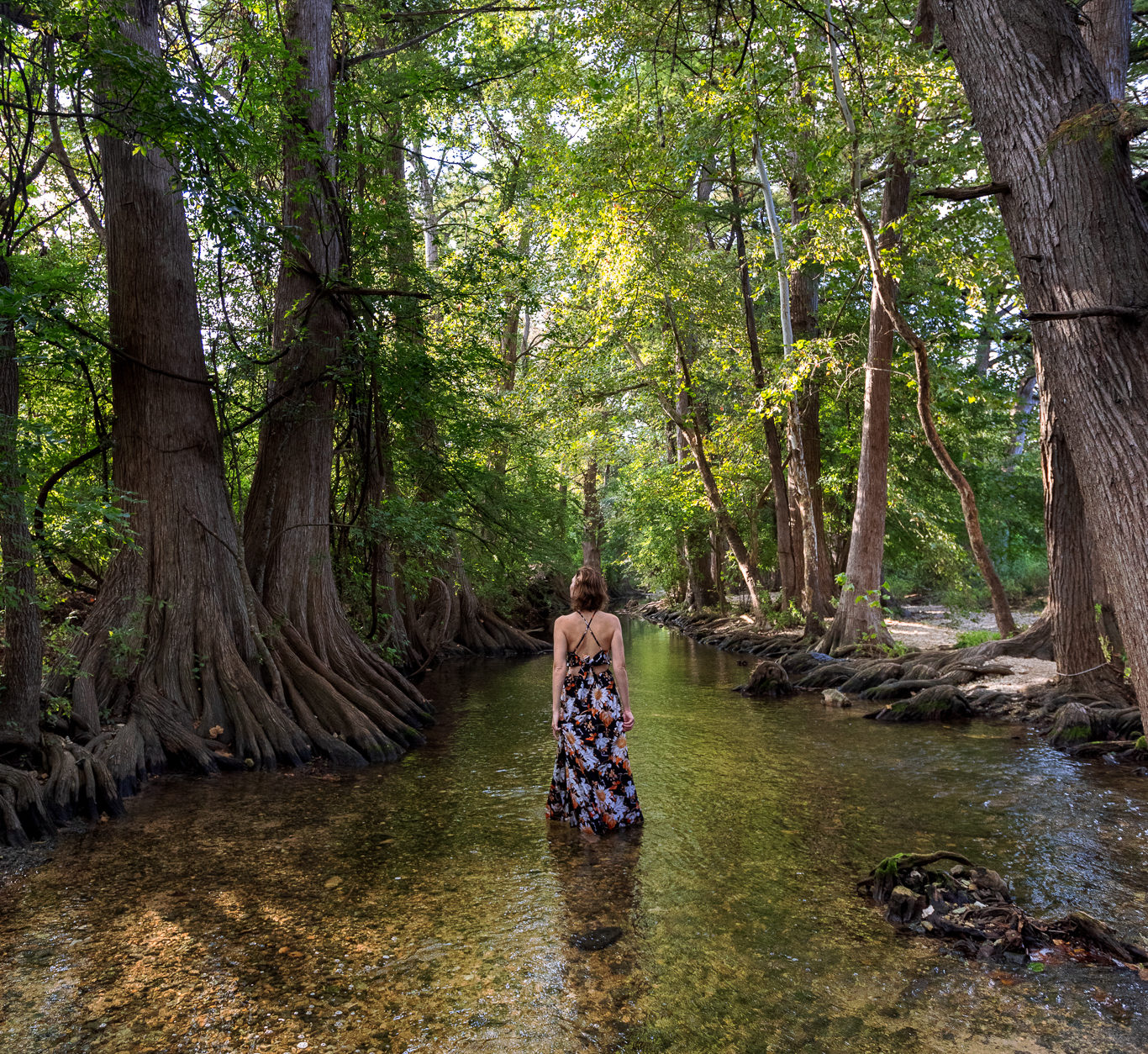 Woman stands in the Cibolo Creek at the Cibolo Nature Center in Boerne, TX.